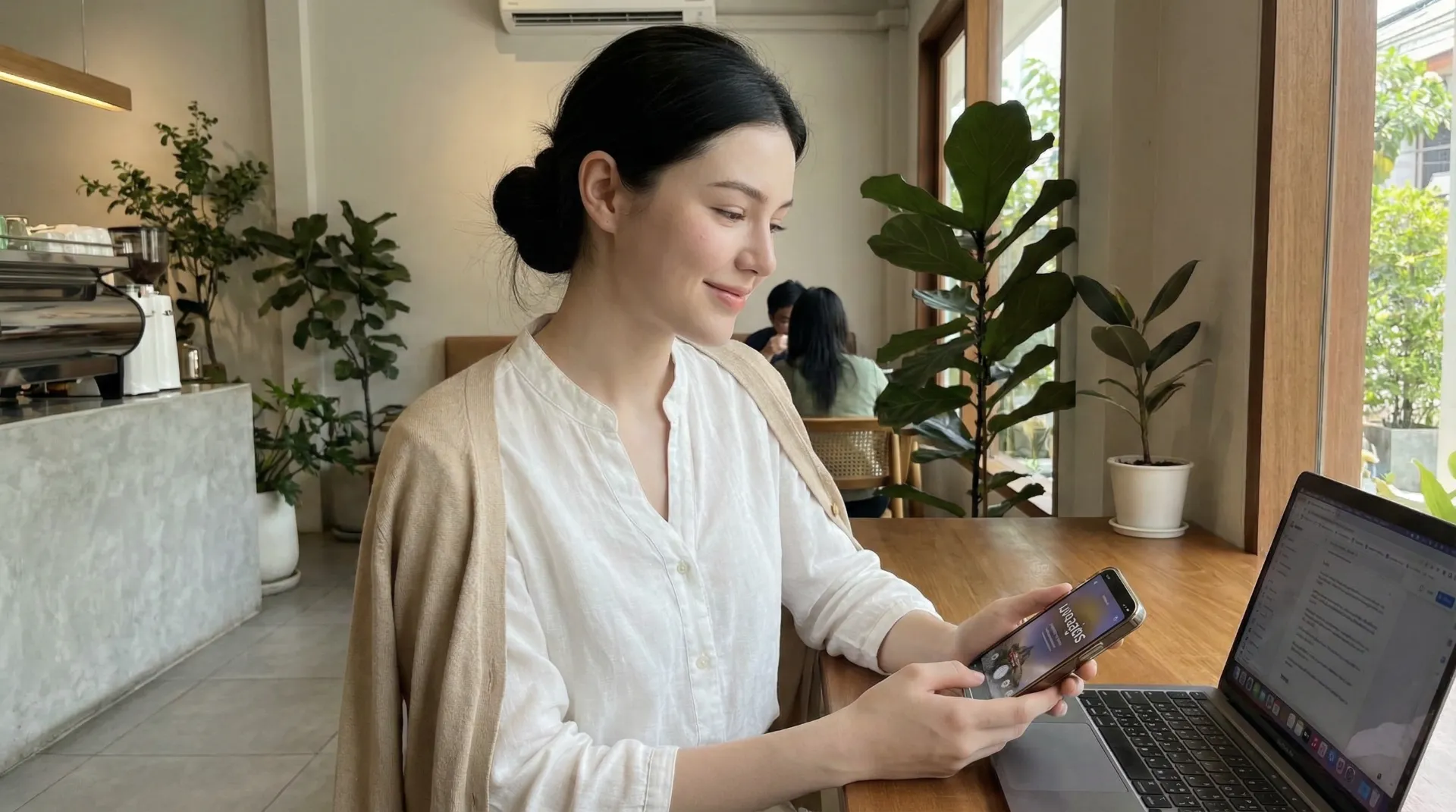 The uploaded reference character sheet shall be used for creating a person or character in this image., Dharma lifestyle blogger, with reference the Uploaded reference image Character Sheet preserving facial fidelity, 25-35 year old Bangkokian, modest and polite attire (white or earth tones), serene and kind expression, neat styling, using a smartphone or laptop mindfully, showing Mangala Sutta application in social media filtering, sitting in a modern cafe or office, balanced and conscious mood, aspect ratio 21:9